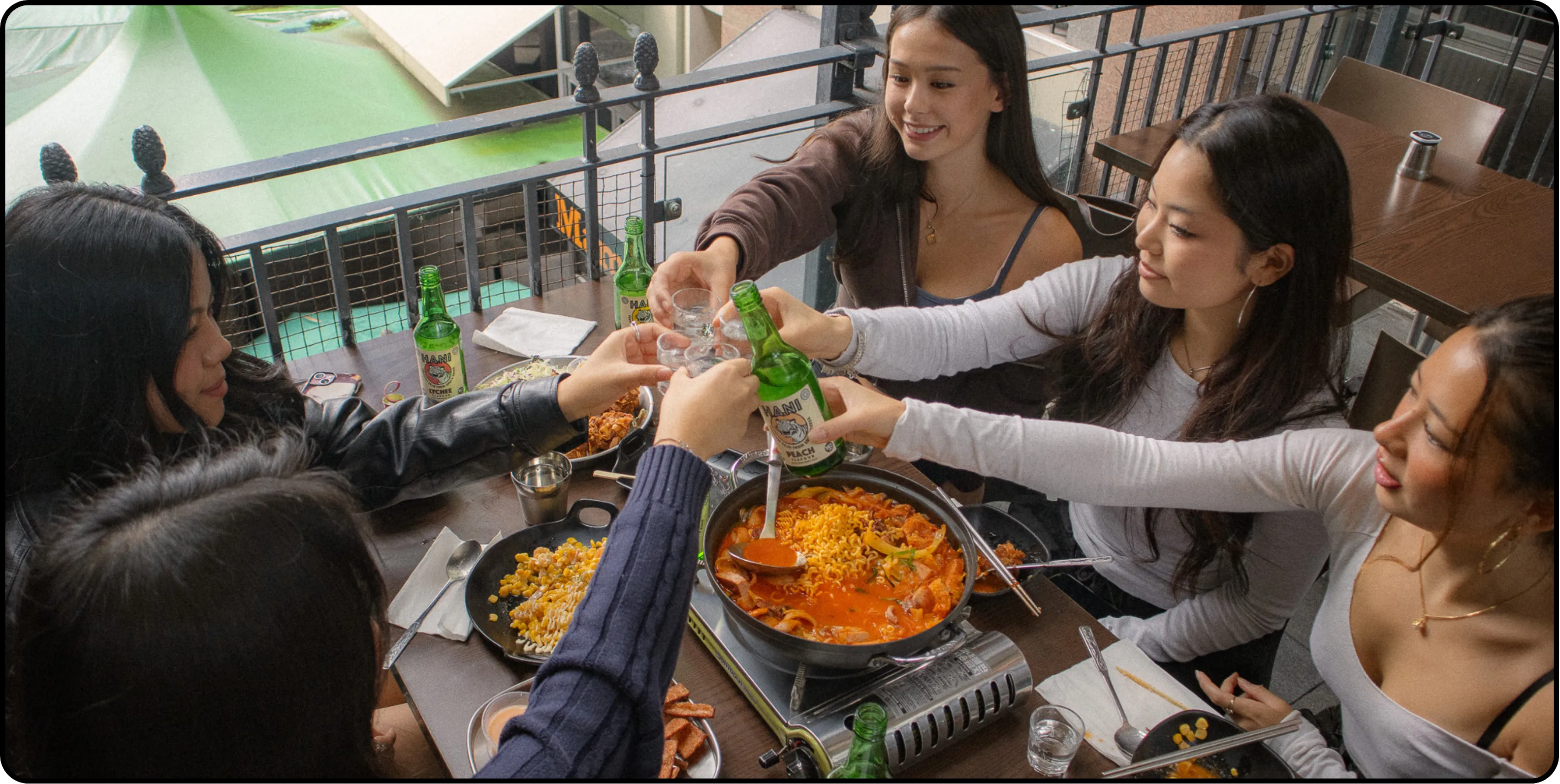 Friends enjoying Hani Korean flavoured soju at a restaurant